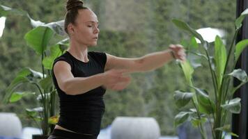 a woman is doing yoga in front of a window video