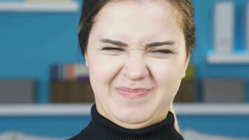 Disgusted by the smell, young woman covers her nose. video