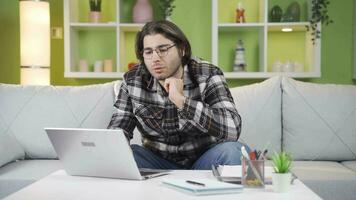 Young man working at home alone muttering to himself. video