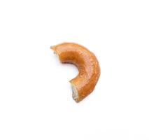 Bitten glazed donut isolated on white background. After some edits. photo