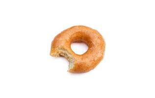Bitten glazed donut isolated on white background. After some edits. photo