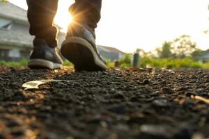 A man's feet perspective from the road in the early morning, focusing on the road. After some edits. photo