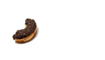 Messy chocolate doughnut isolated on white background, after some edits. photo