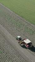 an aerial view of a tractor and trailer loading a truck with potatoes video