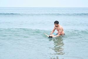 Dad plays with his sons in the sea. photo