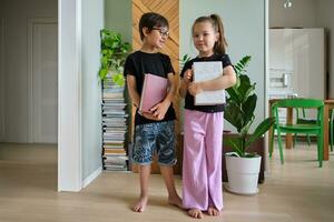 A boy and a girl with books in their hands. photo