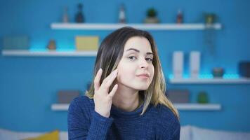 Young woman looking at her skin. video