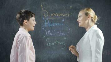 Teacher teaching her girl student the Seasons. video