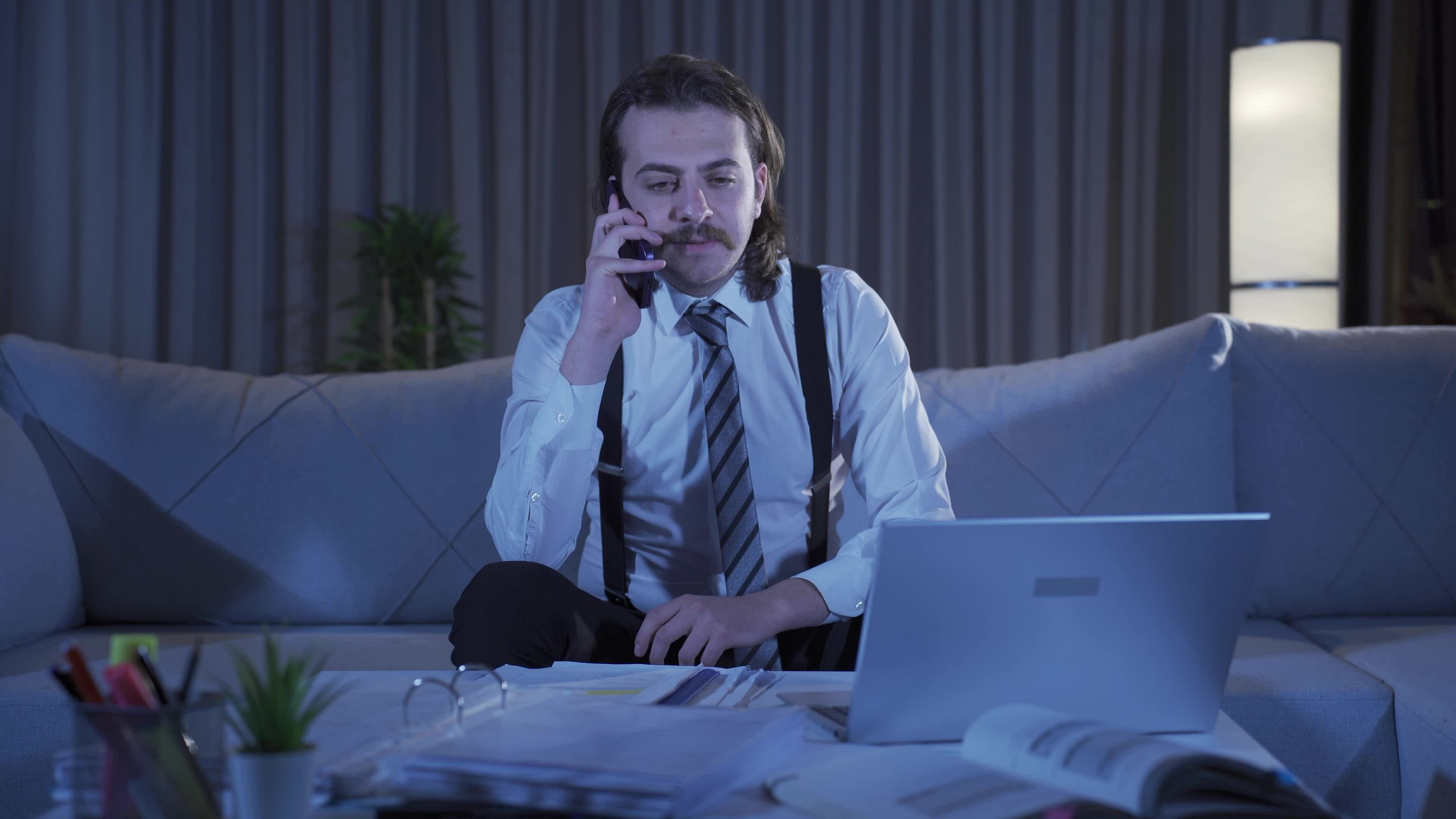Cheerful man making phone call at home. 32518410 Stock Video at Vecteezy