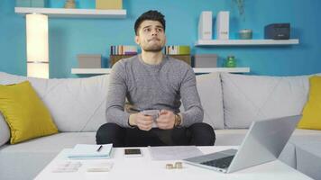 Young man paying bills, using calculator, checking budget. video