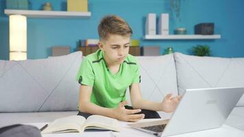 Boy looking confused at laptop. video