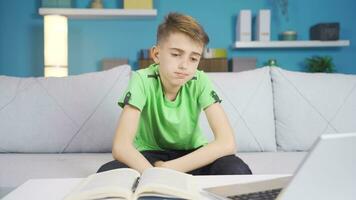 Teen boy sitting on sofa stressed and giving negative nod to camera. video