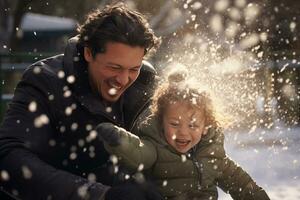 Father playing in snow with child in front of house in winter photo