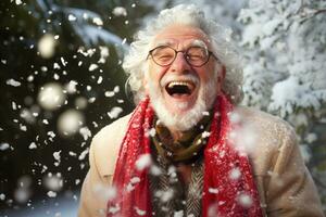 A old man in winter clothes plays in the snow in front of house photo