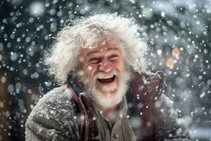 A old man in winter clothes plays in the snow in front of house photo