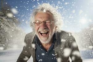 A old man in winter clothes plays in the snow in front of house photo