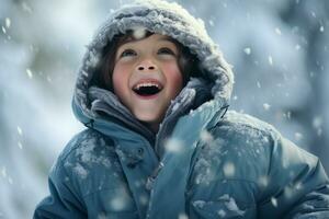 A boy in winter clothes plays in the snow in front of the house photo