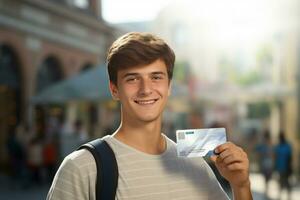 male tourist holding credit card on bokeh city background photo