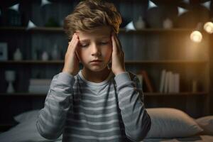 Sick boy having a headache in the living room during the daytime photo