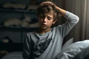 Sick boy having a headache in the living room during the daytime photo