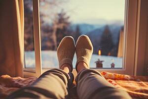 Feet in socks on beautiful winter mountain view background photo