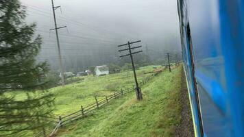 The train passes through a mountain valley in the morning video