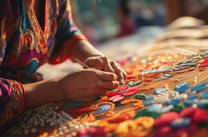 Woman Hands Embroidering Colorful Floral Pattern on Fabric photo