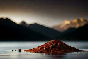 a pile of red powder sitting on the water with mountains in the background. AI-Generated photo