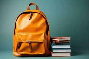 Books and backpack symbolizing education outreach isolated on a gradient background photo