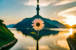 un flor soportes en frente de un torre a puesta de sol. generado por ai foto