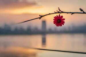 a red flower is on a branch near a lake. AI-Generated photo