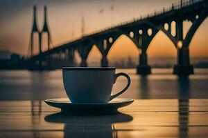 a cup of coffee sits on a table in front of a bridge. AI-Generated photo