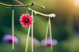 a pink flower hanging from a string. AI-Generated photo