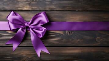 Purple ribbon on a rustic table background with empty space for text photo