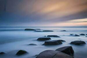 a long exposure photograph of rocks on the beach. AI-Generated photo