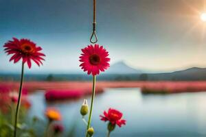 pink flowers are hanging from a hook in front of a lake. AI-Generated photo