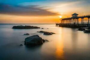 un muelle a puesta de sol con rocas y agua. generado por ai foto