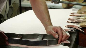 Shoemaker using insole cutting machine at his workshop video