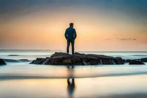 un hombre en pie en un rock a el playa a puesta de sol. generado por ai foto