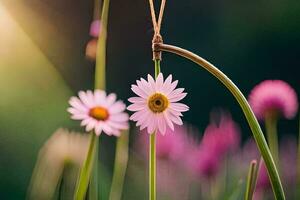 pink flowers hanging from a string in the grass. AI-Generated photo
