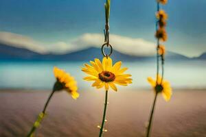yellow flowers hanging from a hook in front of a lake. AI-Generated photo