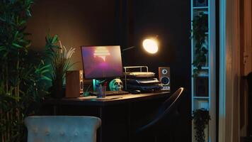 Close up shot of computer screens showing running animation rendering in dimly lit empty home interior. Zoom in on 3D renders on digital displays in cozy apartment living room video