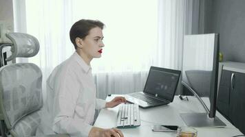 Tired young woman stressing out while working on computers video