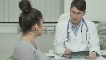 Young woman smiling to the camera during medical appointment at clinic video