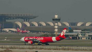 BANGKOK, THAILAND MARCH 01, 2023 - Airbus A330343, HSXTC of AirAsia X braking after landing at Suvarnabhumi Airport, side view. Aircraft arriving video