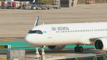PHUKET, THAILAND FEBRUARY 26, 2023 - Footage of passenger plane of Air Astana taxiing at Phuket airport, side view video