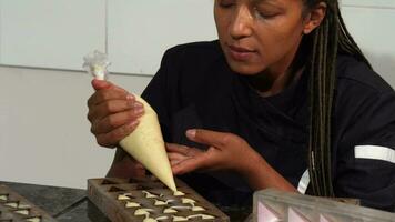 Beautiful mature female chocolatier smiling to the camera while working video