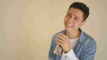 Young Indonesian man with denim style had singing and enjoyed.  The footage is suitable to use for man expression and lifestyle content media. video