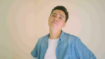 Young Indonesian man with denim style feel sad and lonely.  The footage is suitable to use for man expression and lifestyle content media. video