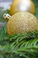 Golden shiny balls in pine branches. Christmas, New Year, holiday background. Copy space photo